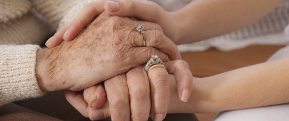 woman holding hands with senior woman