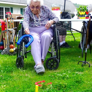Happy woman tosses horseshoe at Windsor nursing home