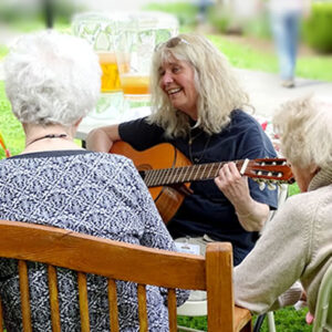 Woman leads residents in a song at Vermont memory care center