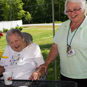 Staff and resident of Vermont memory care facility enjoy time outside together