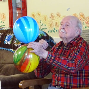 Windsor assisted living center resident holds colorful balls