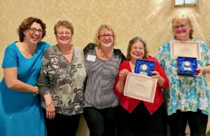 Staff from assisted living center in Windsor hold up awards