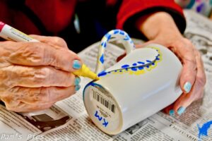 Life in Memory Care - hand painting a mug